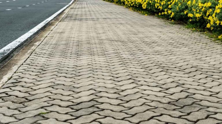 Concrete driveway being sealed as part of a maintenance service